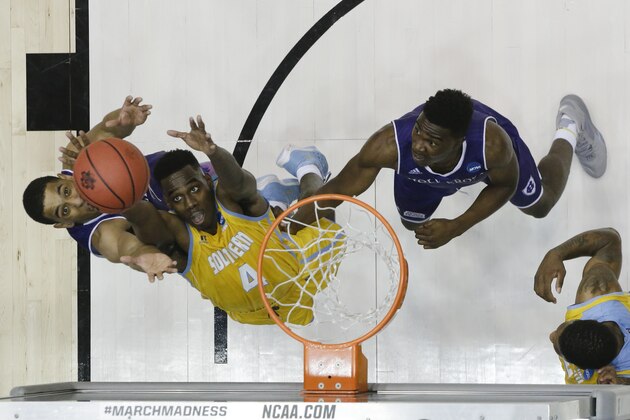 Southern University's Chris Thomas (4) reaches for a rebound against Holy Cross' Cullen Hamilton, left, and Karl Charles, right, during the second half of a First Four game of the NCAA college basketball tournament, Wednesday, March 16, 2016, in Dayton, Ohio. Holy Cross won 59-55. (AP Photo/John Minchillo) Southern University's Chris Thomas (4) reaches for a rebound against Holy Cross' Cullen Hamilton, left, and Karl Charles, right, during the second half of a First Four game of the NCAA college basketball tournament, Wednesday, March 16, 2016, in Dayton, Ohio. Holy Cross won 59-55. (AP Photo/John Minchillo)