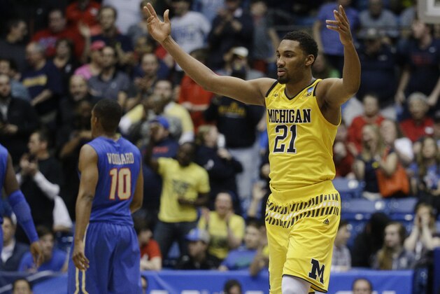 Michigan's Zak Irvin (21) celebrates during the second half of a First Four game of the NCAA college basketball tournament against Tulsa, Wednesday, March 16, 2016, in Dayton, Ohio. Michigan won 67-62. (AP Photo/John Minchillo)