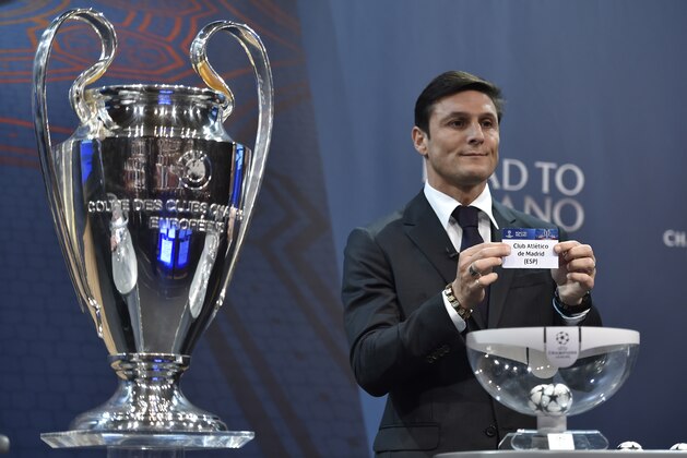 UEFA Champions League final ambassador  Javier Zanetti shows the name of  Athletico Madrid football club during the draw for the UEFA Champions league round of sixteen, on December 14, 2015 at the UEFA headquarters in Nyon.  AFP PHOTO / FABRICE COFFRINI / AFP / FABRICE COFFRINI        (Photo credit should read FABRICE COFFRINI/AFP/Getty Images)