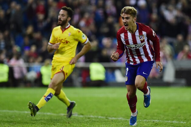 Atletico Madrid's French forward Antoine Griezmann (R) celebrates after scoring during the Spanish league football match Club Atletico de Madrid vs Real Sporting de Gijon at the Vicente Calderon stadium in Madrid on November 8, 2015. AFP PHOTO/ PIERRE-PHILIPPE MARCOU        (Photo credit should read PIERRE-PHILIPPE MARCOU/AFP/Getty Images)