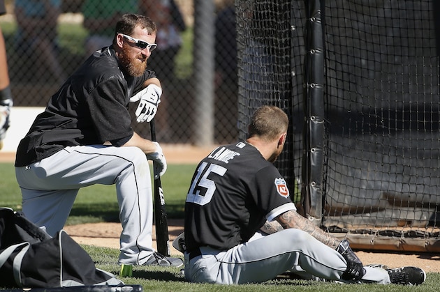 Chicago White Sox's Adam LaRoche, left, talks with Brett Lawrie, right, as the two wait their turn for batting practice during a spring training baseball workout Friday, Feb. 26, 2016, in Glendale, Ariz. (AP Photo/Ross D. Franklin)