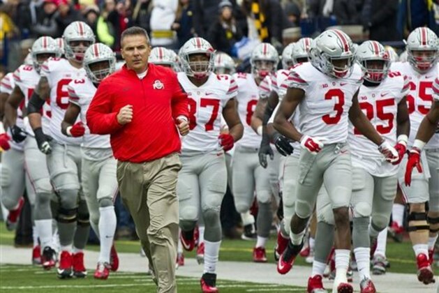 FILE - In this Nov. 28, 2015, file photo, Ohio State head coach Urban Meyer leads his team onto the Michigan Stadium field before an NCAA college football game against Michigan in Ann Arbor, Mich. Ohio State University has extended its current sponsorship contract with Nike by 15 years in a deal worth $252 million. The university and the Beaverton, Oregon-based athletic apparel company announced the deal on Thursday, Jan. 14, 2016. The current partnership had been scheduled to end in July 2018. It will now continue to 2033. (AP Photo/Tony Ding, File)