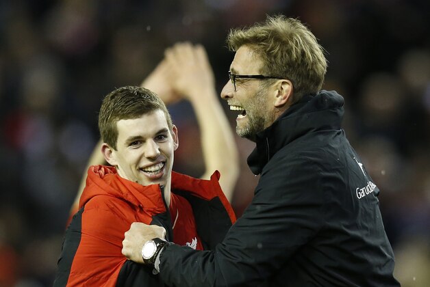Liverpool's manager Juergen Klopp, right, celebrates with player Jon Flanagan after winning the English League Cup semifinal second leg soccer match between Liverpool and Stoke City at Anfield stadium in Liverpool, England, Tuesday, Jan. 26, 2016. (AP Photo/Jon Super)