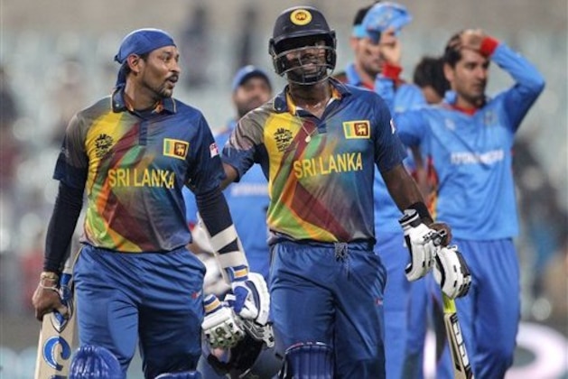 Sri Lanka's Angelo Mathews, right and Tillakaratne Dilshan walk from the field after they defeated Afghanistan by six wickets in their ICC World Twenty20 2016 cricket tournament in Kolkata, India, Thursday, March 17, 2016. (AP Photo/ Bikas Das)