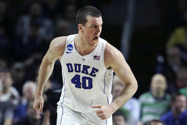 Duke center Marshall Plumlee (40) lets out a yell towards his bench as he heads up court after a basket against North Carolina-Wilmington in the second half during the first round of the NCAA college men's basketball tournament in Providence, R.I., Thursday, March 17, 2016. Plumlee had 23 points as Duke defeated North Carolina-Wilmington 93-85. (AP Photo/Charles Krupa)