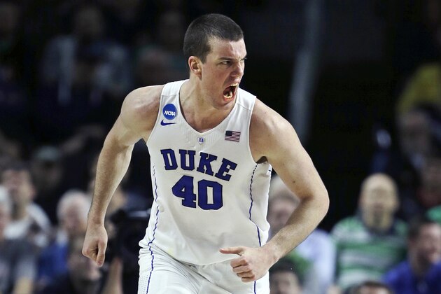 Duke center Marshall Plumlee (40) lets out a yell towards his bench as he heads up court after a basket against North Carolina-Wilmington in the second half during the first round of the NCAA college men's basketball tournament in Providence, R.I., Thursday, March 17, 2016. Plumlee had 23 points as Duke defeated North Carolina-Wilmington 93-85. (AP Photo/Charles Krupa)