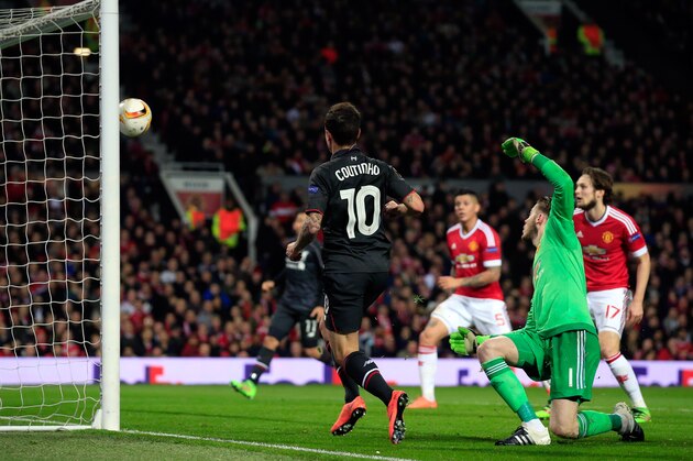 Liverpool’s Philippe Coutinho, center, scores his side’s first goal past United goalkeeper David De Gea during the Europa League round of 16, second leg, soccer match between  Manchester United and Liverpool at Old Trafford Stadium in Manchester, England, Thursday March 17, 2016. (AP Photo/Jon Super)