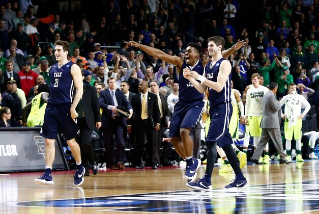 Mar 17, 2016; Providence, RI, USA; Yale Bulldogs guard Nick Victor (21), forward Brandon Sherrod (35), and guard Anthony Dallier (1) celebrate their win over Baylor during  a first round game during the 2016 NCAA Tournament at Dunkin Donuts Center. Mandatory Credit: Mark L. Baer-USA TODAY Sports