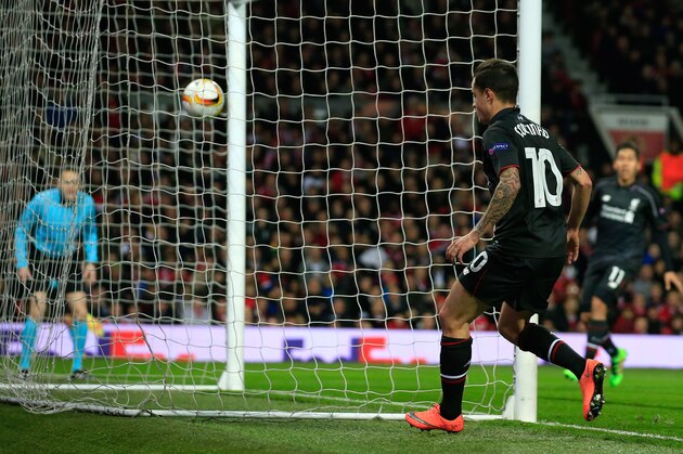 Liverpool’s Philippe Coutinho, center, watches his shot go into the goal for his side’s first goal during the Europa League round of 16, second leg, soccer match between  Manchester United and Liverpool at Old Trafford Stadium in Manchester, England, Thursday March 17, 2016. (AP Photo/Jon Super)