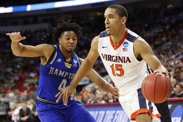Mar 17, 2016; Raleigh, NC, USA; Virginia Cavaliers guard Malcolm Brogdon (15) dribbles the ball around Hampton Pirates guard Lawrence Cooks (4) during the first half at PNC Arena. Mandatory Credit: Geoff Burke-USA TODAY Sports