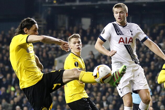 Tottenham’s Eric Dier, center, jumps as Dortmund's Neven Subotic, left, plays the ball during the Europa League round of 16 second leg soccer match between Tottenham Hotspur and Borussia Dortmund in London, Great Britain, Thursday, March 17, 2016. (AP Photo/Frank Augstein)