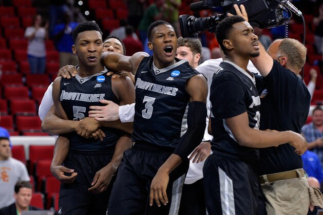 RALEIGH, NC - MARCH 17:  Kris Dunn #3 of the Providence Friars celebrates with teammates Rodney Bullock #5 and Kyron Cartwright #24 after defeating the USC Trojans with a score of 70 to 69 during the first round of the 2016 NCAA Men's Basketball Tournament at PNC Arena on March 17, 2016 in Raleigh, North Carolina.  (Photo by Grant Halverson/Getty Images)