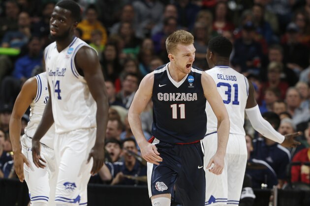 Gonzaga forward Domantas Sabonis, center, celebrates after scoring a basket as Seton Hall guard Ismael Sanogo, left, and forward Angel Delgado turn away during the second half of a first-round men's college basketball game Thursday, March 17, 2016, in the NCAA Tournament in Denver. Gonzaga won 68-52. (AP Photo/David Zalubowski)