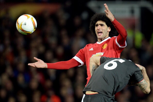 Manchester United's Belgian midfielder Marouane Fellaini gestures after a clash with Liverpool's Croatian defender Dejan Lovren during the UEFA Europa League round of 16, second leg football match between Manchester United and Liverpool at Old Trafford in Manchester, north west England on March 17, 2016. / AFP / OLI SCARFF        (Photo credit should read OLI SCARFF/AFP/Getty Images)