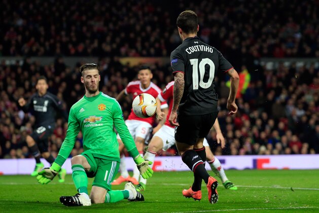 Liverpool’s Philippe Coutinho, right, scores his side’s first goal past United goalkeeper David De Gea during the Europa League round of 16, second leg, soccer match between  Manchester United and Liverpool at Old Trafford Stadium in Manchester, England, Thursday March 17, 2016. (AP Photo/Jon Super)