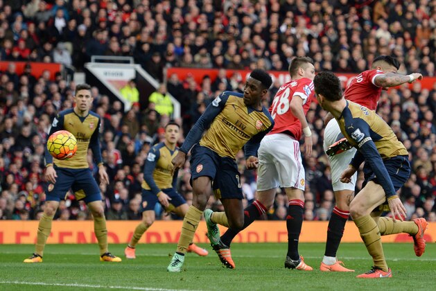 Arsenal's English striker Danny Welbeck (C) scores their first goal during the English Premier League football match between Manchester United and Arsenal at Old Trafford in Manchester in north west England on February 28, 2016. / AFP / OLI SCARFF / RESTRICTED TO EDITORIAL USE. No use with unauthorized audio, video, data, fixture lists, club/league logos or 'live' services. Online in-match use limited to 75 images, no video emulation. No use in betting, games or single club/league/player publications.  /         (Photo credit should read OLI SCARFF/AFP/Getty Images)