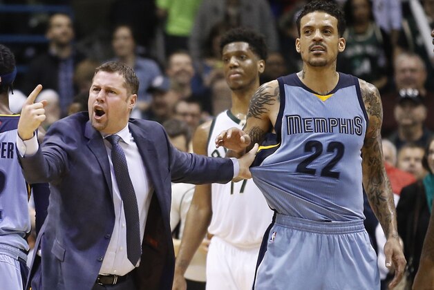 Memphis Grizzlies head coach David Joerger holds back Matt Barnes (22) after a double technical was called on Joerger and Milwaukee Bucks' John Henson during the second half of an NBA basketball game Thursday, March 17, 2016, in Milwaukee. The Bucks won 96-86. (AP Photo/Morry Gash)