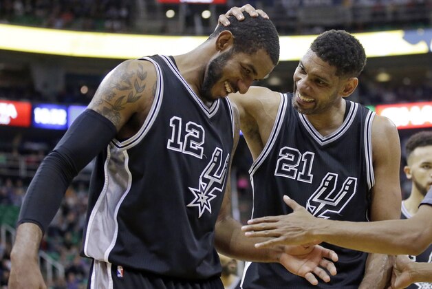 San Antonio Spurs center Tim Duncan (21) and forward LaMarcus Aldridge (12) celebrate as they walk off court during the second half in an NBA basketball game against the Utah Jazz on Thursday, Feb. 25, 2016, in Salt Lake City. The Spurs won 96-78. (AP Photo/Rick Bowmer)