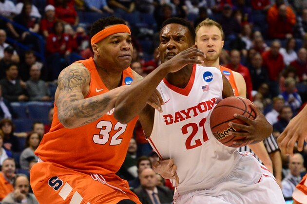 Mar 18, 2016; St. Louis, MO, USA; Dayton Flyers forward Dyshawn Pierre (21) works to break through the defense of Syracuse Orange center DaJuan Coleman (32)  during the first half of the first round in the 2016 NCAA Tournament at Scottrade Center. Mandatory Credit: Jeff Curry-USA TODAY Sports