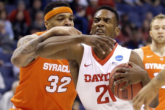Dayton's Dyshawn Pierre, right, heads to the basket as Syracuse's DaJuan Coleman defends during the first half in a first-round men's college basketball game in the NCAA tournament, Friday, March 18, 2016, in St. Louis. (AP Photo/Jeff Roberson)