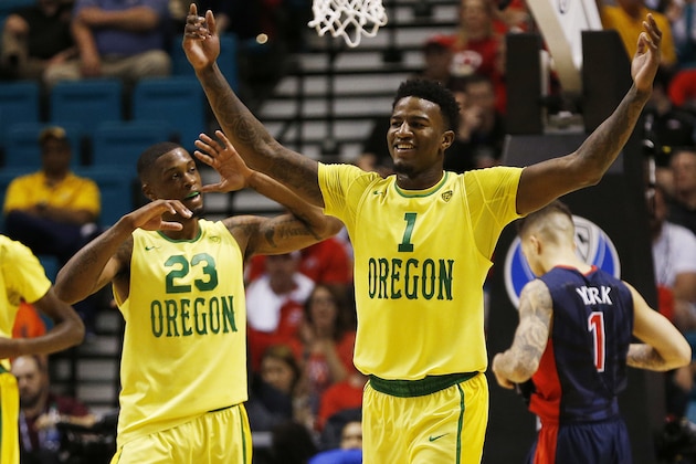 Oregon forward Jordan Bell (1) and forward Elgin Cook (23) react after defeating Arizona in an NCAA college basketball game in the semifinal round of the Pac-12 men's tournament Friday, March 11, 2016, in Las Vegas. Oregon won in overtime 95-89. (AP Photo/John Locher)