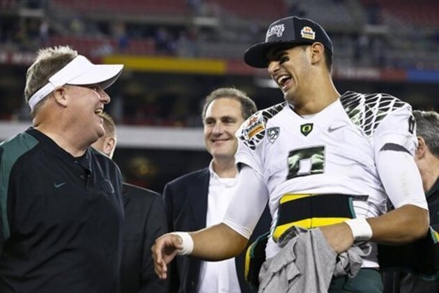 Oregon head coach Chip Kelly, left, laughs with Marcus Mariota after the Fiesta Bowl NCAA college football game against Kansas State Thursday, Jan. 3, 2013, in Glendale, Ariz.  Oregon defeated Kansas State 35-17.(AP Photo/Ross D. Franklin)