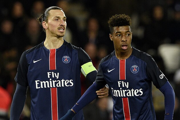 Paris Saint-Germain's Swedish forward Zlatan Ibrahimovic (L) and French defender Presnel Kimpembe are pictured during the French L1 football match between Paris Saint-Germain (PSG) vs Angers on January 23, 2016 at the Parc des Princes stadium in Paris.  / AFP / FRANCK FIFE        (Photo credit should read FRANCK FIFE/AFP/Getty Images)