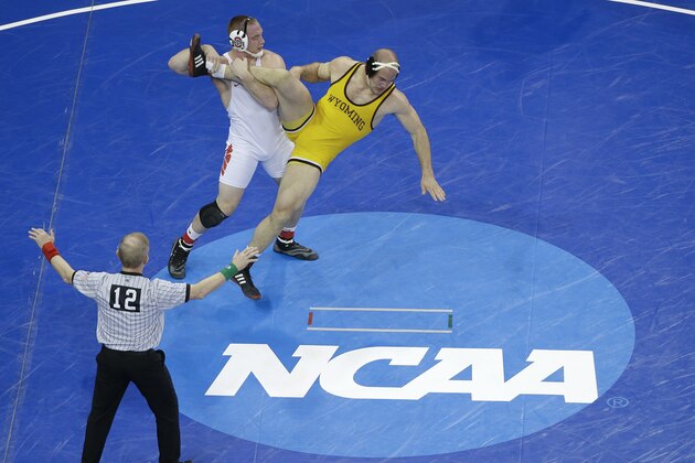 Ohio State's Kyle Snyder, left, takes down Wyoming's Tanner Harms in a 285 pound weight class match during the second round of the NCAA Divison I Wrestling Championships, Thursday, March 17, 2016, in New York. Snyder won the match. (AP Photo/Julie Jacobson)