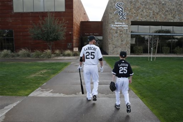 FILE - In this Feb. 28, 2015, file photo, Chicago White Sox's Adam LaRoche, left, and his son Drake walk to the White Sox's clubhouse during a photo day before a baseball spring training workout in Phoenix. Kudos to Adam LaRoche for wanting to spend time with his son, and walking away from a $13 million salary to make sure that happened. But there's nothing wrong with the White Sox telling the now-retired first baseman that