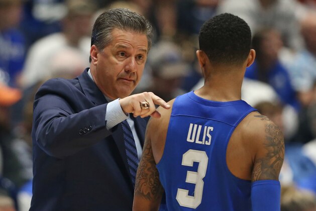 Kentucky head coach John Calipari, left, talks with Tyler Ulis, right, during the second half of an NCAA college basketball game against Texas A&M in the championship of the Southeastern Conference tournament in Nashville, Tenn., Sunday, March 13, 2016. (AP Photo/John Bazemore)