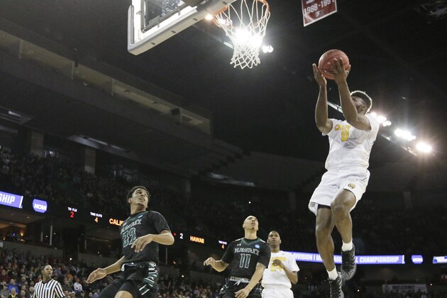 California forward Jaylen Brown (0) shoots in front of Hawaii guard Aaron Valdes (32) and guard Quincy Smith (11) during the first half of a first-round men's college basketball game in the NCAA Tournament in Spokane, Wash., Friday, March 18, 2016. (AP Photo/Young Kwak)