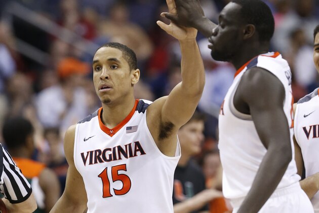Virginia guard Malcolm Brogdon (15) gives a high-five to guard Marial Shayok (4) during the second half of an NCAA college basketball game against Miami in the Atlantic Coast Conference  men'stournament, Friday, March 11, 2016, in Washington. Virginia defeated Miami 73-68. (AP Photo/Steve Helber)