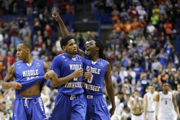 Middle Tennessee Darnell Harris (0), Perrin Buford (2) and Jaqawn Raymond, left, celebrate as they walk off the court after winning a first-round men's college basketball game against Michigan State in the NCAA Tournament, Friday, March 18, 2016, in St. Louis. Middle Tennessee won 90-81. (AP Photo/Charlie Riedel)