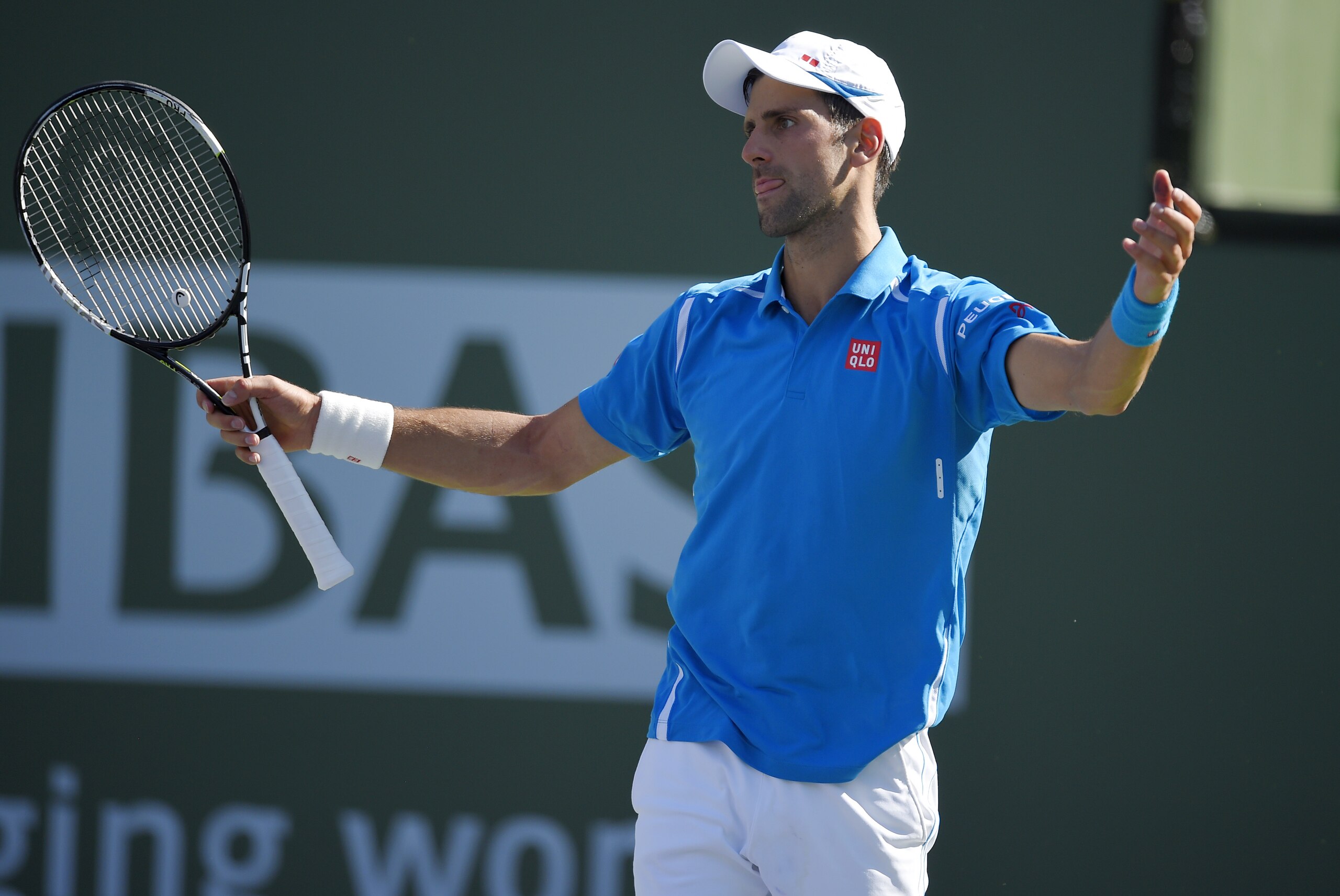 Novak Djokovic, of Serbia, reacts while playing Jo-Wilfried Tsonga, of France, during their quarterfinal match at the BNP Paribas Open tennis tournament, Friday, March 18, 2016, in Indian Wells, Calif. (AP Photo/Mark J. Terrill)