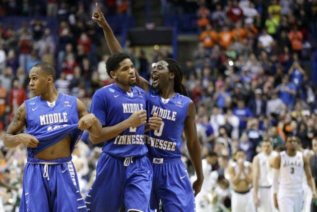 Middle Tennessee Darnell Harris (0), Perrin Buford (2) and Jaqawn Raymond, left, celebrate as they walk off the court after winning a first-round men's college basketball game against Michigan State in the NCAA Tournament, Friday, March 18, 2016, in St. Louis. Middle Tennessee won 90-81. (AP Photo/Charlie Riedel)