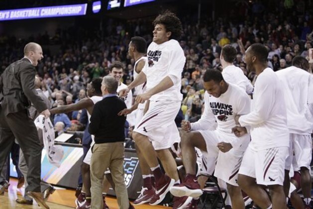 Saint Joseph's players and coaches celebrate after winning a first-round men's college basketball game in the NCAA Tournament against Cincinnati in Spokane, Wash., Friday, March 18, 2016. Saint Joseph's won 78-76. (AP Photo/Young Kwak)