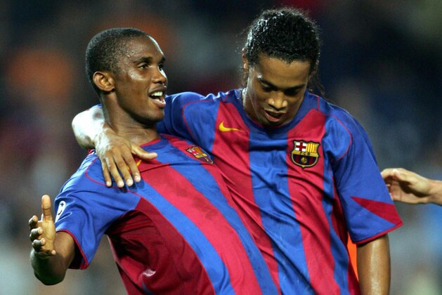 BARCELONA, SPAIN:  FC Barcelona's Samuel Eto'o (L) of Cameroon and Brazilian's Ronaldinho celebrate their third goal against FC Xakhtar during their Group F European Champions League football match at the Camp Nou stadium in Barcelona 29 September 2004. AFP PHOTO/LLUIS GENE.  (Photo credit should read LLUIS GENE/AFP/Getty Images)