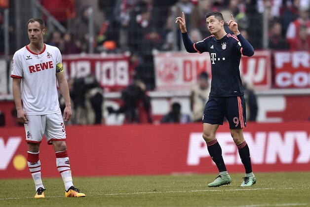 Bayern's Robert Lewandowski, right, celebrates after scoring during the German Bundesliga soccer match between 1. FC Cologne and Bayern Munich in Cologne, Germany, Saturday, March 19, 2016. (AP Photo/Martin Meissner)