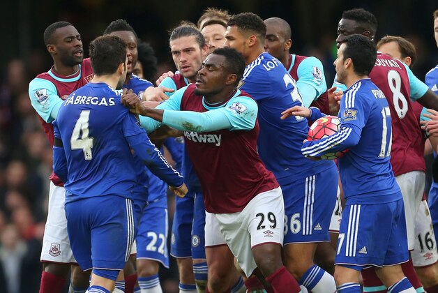 LONDON, ENGLAND - MARCH 19 :  Emmanuel Emenike of West Ham United pushes Cesc Fabregas of Chelsea after he clashes with Andy Carroll of West Ham United during the Barclays Premier League match between Chelsea and West Ham United at Stamford Bridge on March 19, 2016 in London, England.  (Photo by Catherine Ivill - AMA/Getty Images)