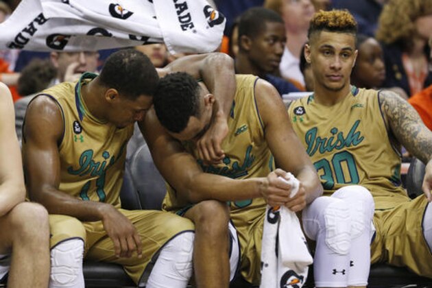 Notre Dame guard Demetrius Jackson, left, consoles forward Bonzie Colson, center as they sit on the bench with forward Zach Auguste (30) during the second half of an NCAA college basketball game against North Carolina in the Atlantic Coast Conference men's tournament, Friday, March 11, 2016, in Washington. North Carolina defeated Notre Dame 78-47. (AP Photo/Steve Helber)