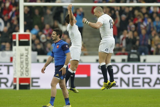 England's Ben Youngs and Mike Brown, right, celebrate at the end pf the Six Nations international rugby match between France and England at the Stade de France stadium in Saint-Denis, outside Paris, Saturday, March 19, 2016. England won the game to clinch the Grand Slam. (AP Photo/Christophe Ena)