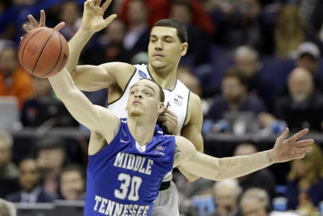 Middle Tennessee's Reggie Upshaw, front, reaches for a rebound along with Michigan State's Gavin Schilling during the second half in a first-round men's college basketball game in the NCAA tournament, Friday, March 18, 2016, in St. Louis. Middle Tennessee won 90-81. (AP Photo/Jeff Roberson)
