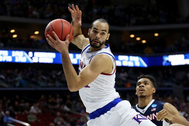 DES MOINES, IA - MARCH 19:  Perry Ellis #34 of the Kansas Jayhawks rebounds against Shonn Miller #32 of the Connecticut Huskies in the first half during the second round of the 2016 NCAA Men's Basketball Tournament at Wells Fargo Arena on March 19, 2016 in Des Moines, Iowa.  (Photo by Jonathan Daniel/Getty Images)
