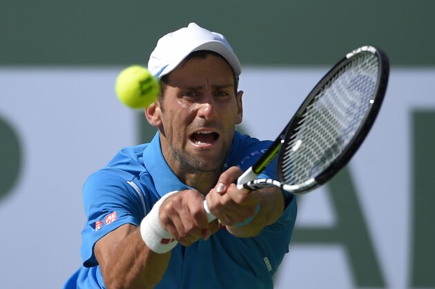 Novak Djokovic, of Serbia, returns to Rafael Nadal, of Spain, during a semifinal at the BNP Paribas Open tennis tournament, Saturday, March 19, 2016, in Indian Wells, Calif. Djokovic won 7-6 (5), 6-2. (AP Photo/Mark J. Terrill)