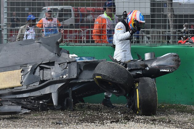 McLaren driver Fernando Alonso of Spain emerges from the wreck of his car after he collided with Haas driver Esteban Gutierrez of Mexico during the Australian Formula One Grand Prix at Albert Park in Melbourne, Australia, Sunday, March 20, 2016. (AP Photo/Theo Karanikos)