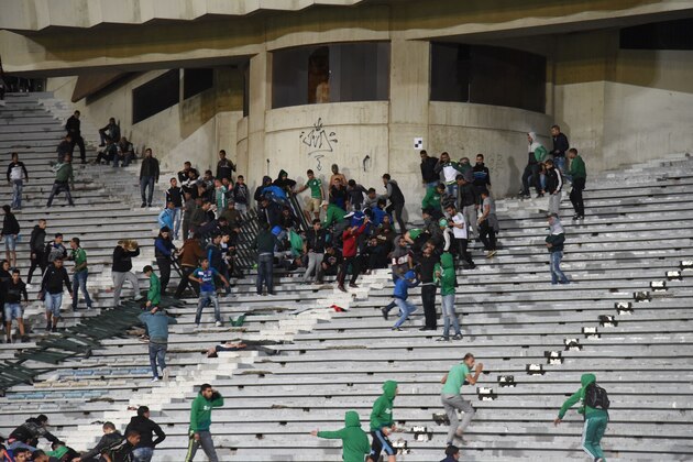 Rival fans of Raja de Casablanca football club clash at the end of a football match between their team and Chabab Rif Al Hoceima on March 19, 2016, at the Mohammed V stadium in Moroccan city of Casablanca. / AFP / STR        (Photo credit should read STR/AFP/Getty Images)