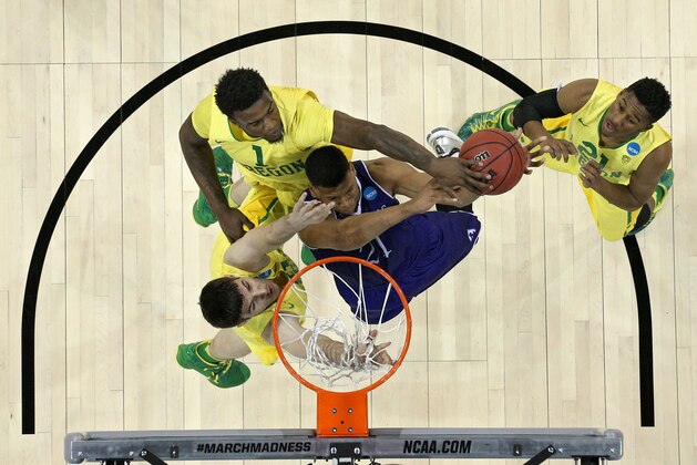 SPOKANE, WA - MARCH 18: Malachi Alexander #21 of the Holy Cross Crusaders has his shot blocked by Jordan Bell #1 of the Oregon Ducks in the first half during the first round of the 2016 NCAA Men's Basketball Tournament at Spokane Veterans Memorial Arena on March 18, 2016 in Spokane, Washington. (Photo by Patrick Smith/Getty Images)