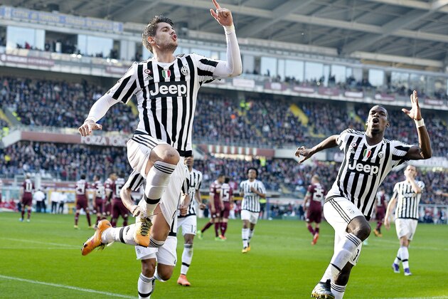 Juventus' Alvaro Morata, left, celebrates with teammate Paul Pogba after scoring during a Serie A soccer match between Torino and Juventus at Turin's Olympic stadium, Sunday, March 20, 2016. (Alessandro Di Marco/ANSA via AP)