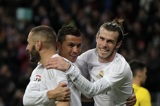 Real Madrid's Welsh forward Gareth Bale (R), Real Madrid's French forward Karim Benzema (L) and Real Madrid's Portuguese forward Cristiano Ronaldo (C) celebrate scoring during the Spanish league football match Real Madrid CF vs Sevilla FC at the Santiago Bernabeu stadium in Madrid on March 20, 2016. / AFP / PEDRO ARMESTRE        (Photo credit should read PEDRO ARMESTRE/AFP/Getty Images)