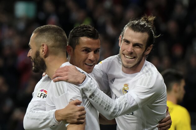 Real Madrid's Welsh forward Gareth Bale (R), Real Madrid's French forward Karim Benzema (L) and Real Madrid's Portuguese forward Cristiano Ronaldo (C) celebrate scoring during the Spanish league football match Real Madrid CF vs Sevilla FC at the Santiago Bernabeu stadium in Madrid on March 20, 2016. / AFP / PEDRO ARMESTRE        (Photo credit should read PEDRO ARMESTRE/AFP/Getty Images)